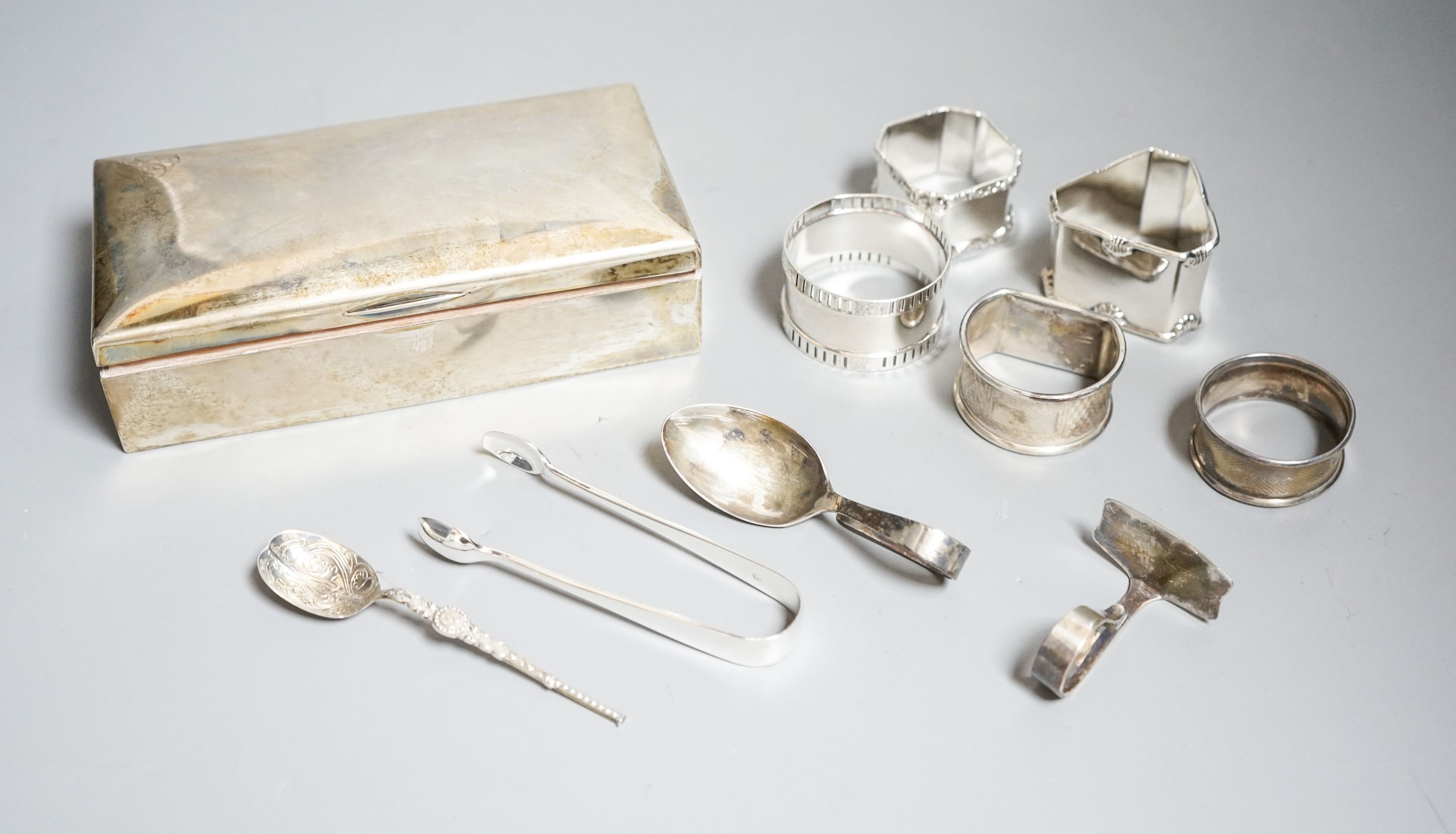 Small silver including a German 800 mounted cigarette box, five napkin rings, spoons etc.